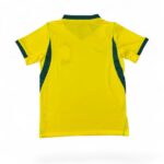 Back view of a bright yellow sports jersey with dark green side panels and trim on sleeves and collar.