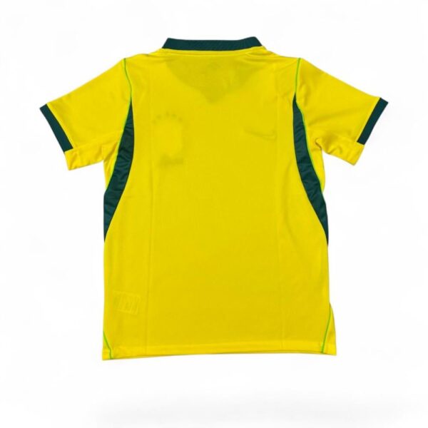 Back view of a bright yellow sports jersey with dark green side panels and trim on sleeves and collar.