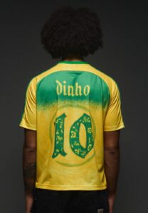 Back view of a person wearing a green and yellow sports jersey with the name 'dinho' and the number 10 on the back.