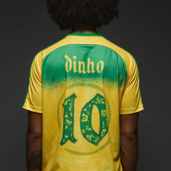 Back view of a person wearing a green and yellow sports jersey with the name 'dinho' and the number 10 on the back.
