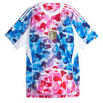 Bright multicolored camouflage jersey with white sleeves and Adidas-style three stripes on the shoulders, front badge centered.