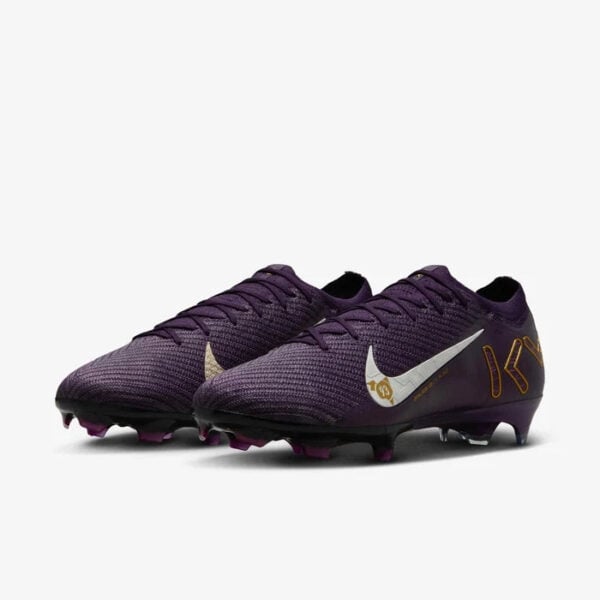 Pair of purple Nike soccer cleats with a white swoosh and gold accents, showing studded soles.