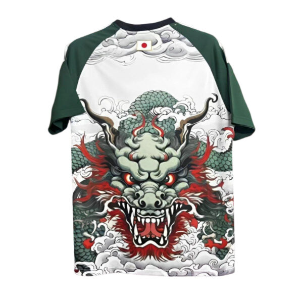 T‑shirt with a bold green dragon head illustration emerging from clouds on a white body with green sleeves and a small Japanese flag at the neckline.