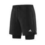 ae1870e5_c1afd663-0cd0-4811-96e1-f2b0695dcb0b | UAE SPORT STORE Black Adidas athletic shorts with an inner compression layer visible, featuring a drawstring waist and logo on the leg.