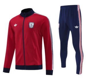 af56a953 | UAE SPORT STORE Red Arsenal track jacket with navy collar and crest, beside navy track pants with red/white stripes.