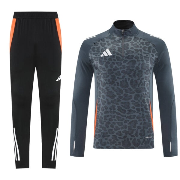 Athletic tracksuit: long-sleeve camo-print top with orange side panels and matching black jogger pants with orange accents.