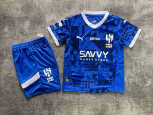 Blue geometric soccer jersey with white trim and matching shorts, featuring Puma logo and Savvy Games Group sponsor.