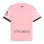 anSGf8SXMKeaa8h | UAE SPORT STORE Back view of a pink short-sleeve shirt with a small black '#SIAMO AQUILE' logo near the neckline and a large 'inx aero' logo on the lower back; sleeves have light pink patterns and dark cuff trim.