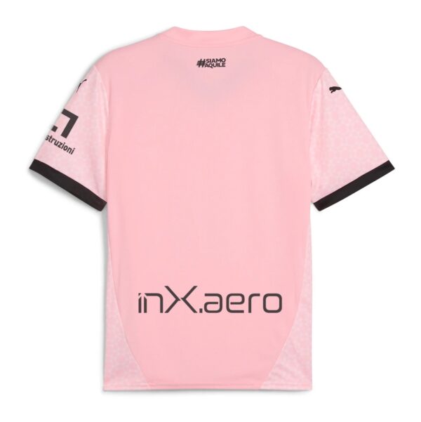 Back view of a pink short-sleeve shirt with a small black '#SIAMO AQUILE' logo near the neckline and a large 'inx aero' logo on the lower back; sleeves have light pink patterns and dark cuff trim.