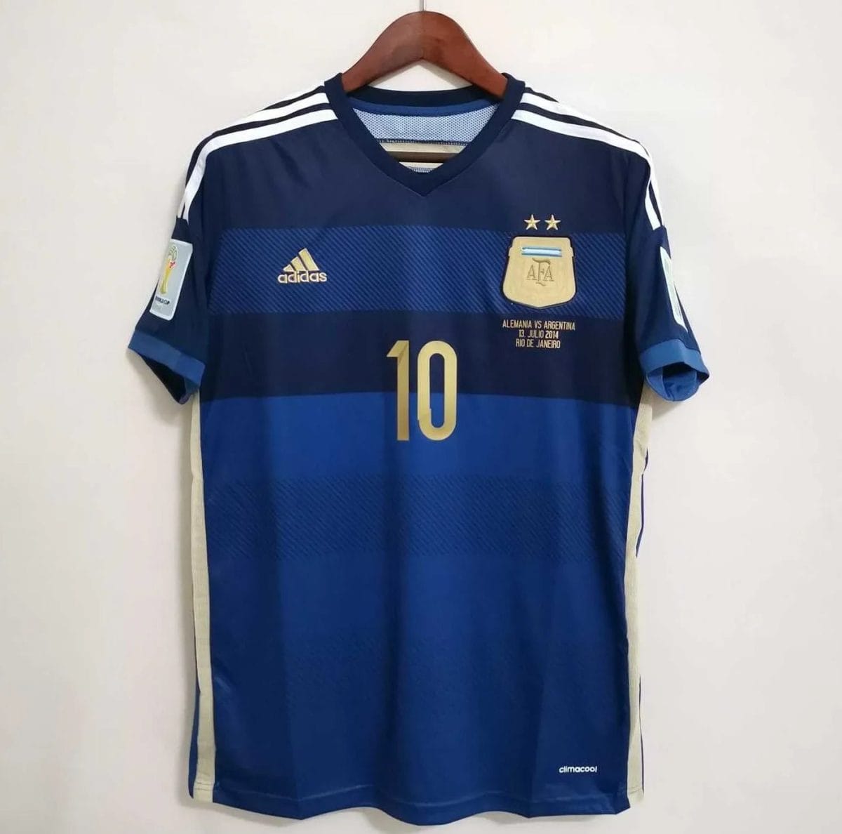 Dark-blue Argentina shirt with gold front number 10 and sleeve badges, full front view on hanger