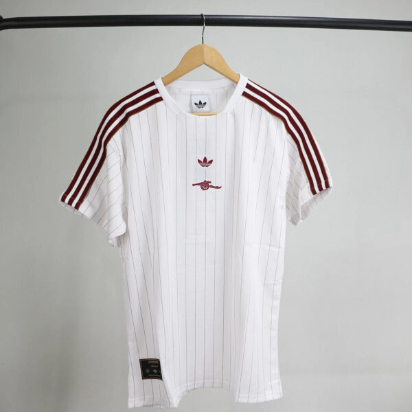 White pinstriped athletic jersey with maroon adidas three-stripe sleeves on a wooden hanger.