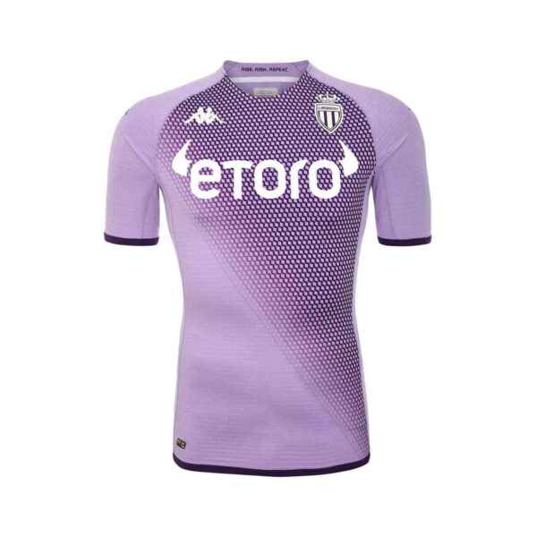 Purple AS Monaco soccer jersey with a geometric gradient pattern, white etoro sponsor logo, and club crest.