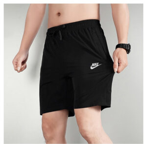 b003c562 | UAE SPORT STORE Man wearing black Nike athletic shorts with a white swoosh logo, standing with hands at his sides to show the fit and length above the knee.”,