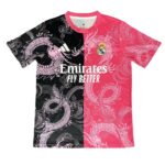 Split-color Real Madrid jersey: black left half, pink right half, dragon pattern, crest, Adidas logo, and 'Emirates Fly Better' text.