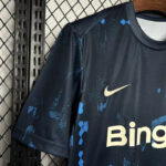 Dark blue Nike sports jersey on a hanger, featuring a gold swoosh and large 'Bing' sponsor text with blue abstract pattern