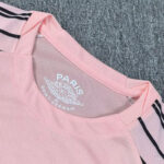 Close-up of a pink polo shirt collar with Paris Saint‑Germain logo printed on the inside back neck.