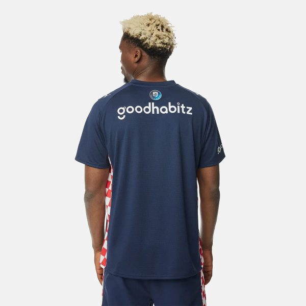 Back view of a man in a navy sports jersey, with 'goodhabit z' text on the upper back and red-and-white side panels, standing against a light background.