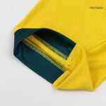 b4a544b9-cdf5-46e9-9cb7-428c0754c8cb | UAE SPORT STORE Close-up of a yellow fabric sleeve with a teal cuff and visible stitching detailing.