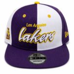 Purple and white Los Angeles Lakers snapback hat with yellow embroidery reading 'Lakers' across the front and side logos visible.