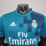 b5a32e7a_5b858866-56f3-45f4-bc1f-10ef2c31f9bc | UAE SPORT STORE Teal Real Madrid football jersey with Adidas logo and club crest, showing the 'Fly Emirates' sponsor text.