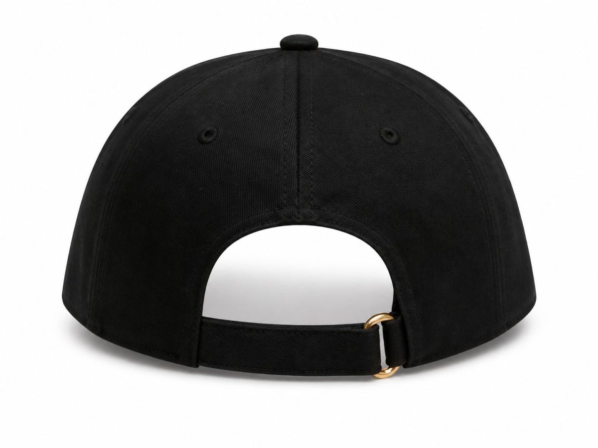 Back view of a black baseball cap with an adjustable strap and gold buckle attached to a small ring