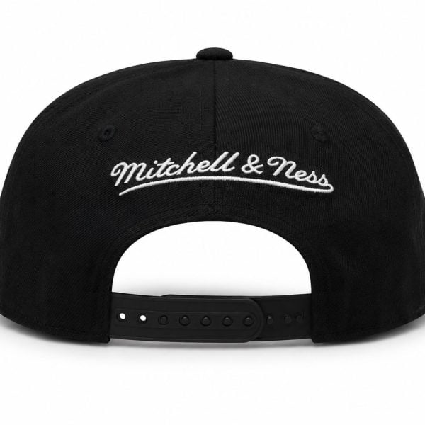 Back view of a black adjustable baseball cap with white embroidered 'Mitchell & Ness' logo on the rear panel and a plastic strap closure.
