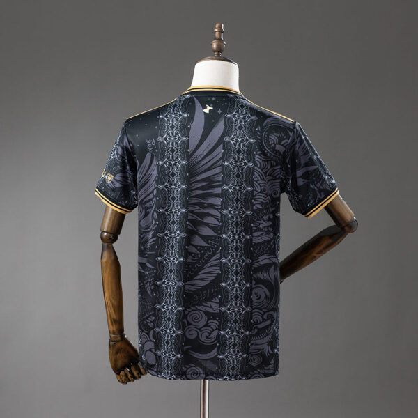 Back view of a black short-sleeve t-shirt with an ornate vertical grey pattern displayed on a dress form/session mannequin back