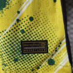 Close-up of high-visibility yellow fabric with green speckles and a black patch reading ENGINEERED.