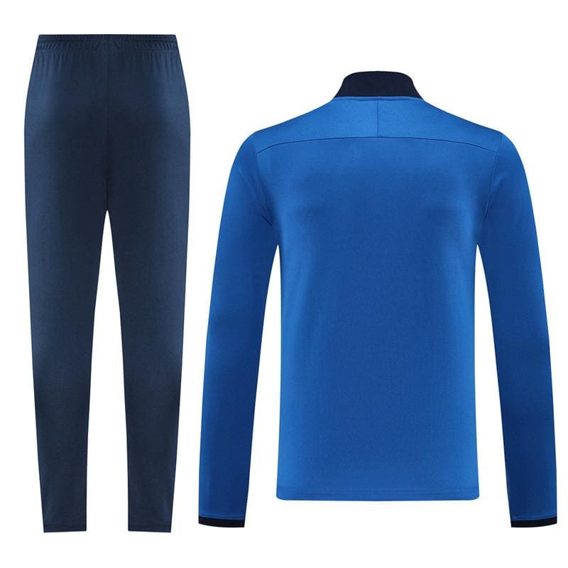 b7d99662-80cb-48c0-9281-07c3a2089834 | UAE SPORT STORE Blue athletic tracksuit: dark blue jogger pants and matching long-sleeve jacket with black collar cuffs, front view.