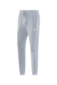 Light gray joggers with a drawstring waist, neon Nike swoosh on the left thigh and FC Barcelona crest on the right hip.