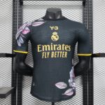 Mannequin wearing a Real Madrid football jersey with the yellow crest, Emirates Fly Better slogan, and a dark patterned fabric.