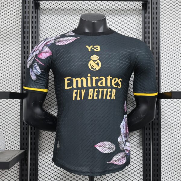 Mannequin wearing a Real Madrid football jersey with the yellow crest, Emirates Fly Better slogan, and a dark patterned fabric.