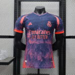b8ff287a | UAE SPORT STORE Real Madrid football jersey on a mannequin, purple-pink splash design with Emirates Fly Better sponsor and team crest on the chest.