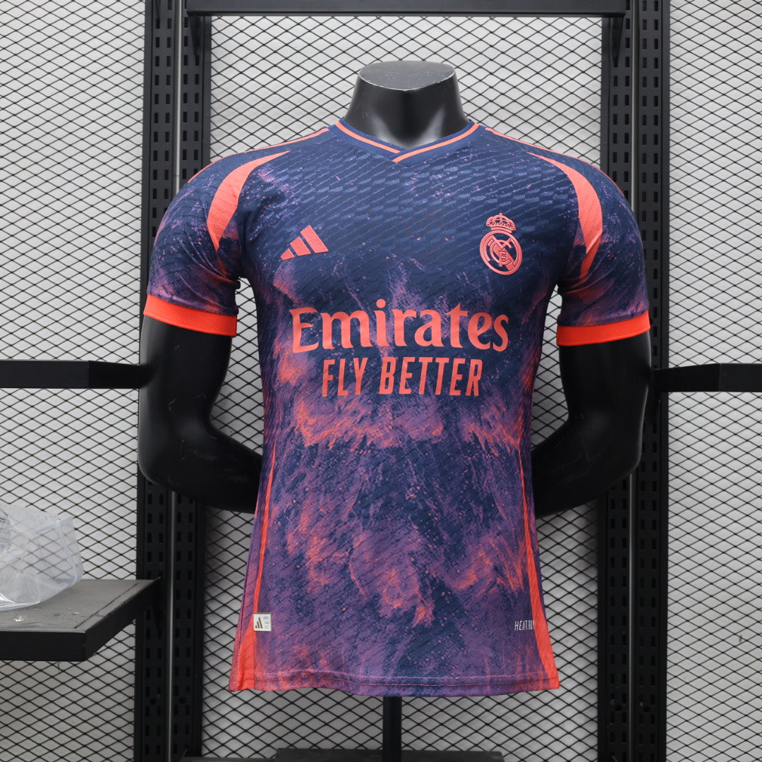 b8ff287a | UAE SPORT STORE Real Madrid football jersey on a mannequin, purple-pink splash design with Emirates Fly Better sponsor and team crest on the chest.