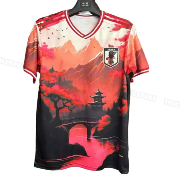 Jersey on a hanger: red-to-black Japanese national soccer jersey with a mountainous landscape and pagoda design and JFA crest on the chest