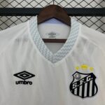 White striped sports jersey on a hanger, showing a blue zigzag-trim collar and the Umbro logo; crest with stars is partially visible on the right side.
