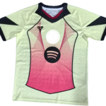 Front view of a lime-green athletic jersey with pink center panel, black trim, and a circular dark logo on the chest.