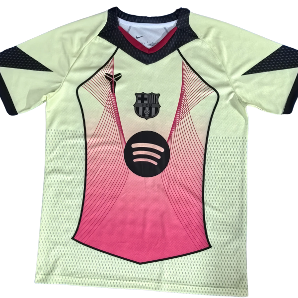 Light green soccer jersey with pink front panel, dark trim, and Spotify logo; FCB crest near the chest area.