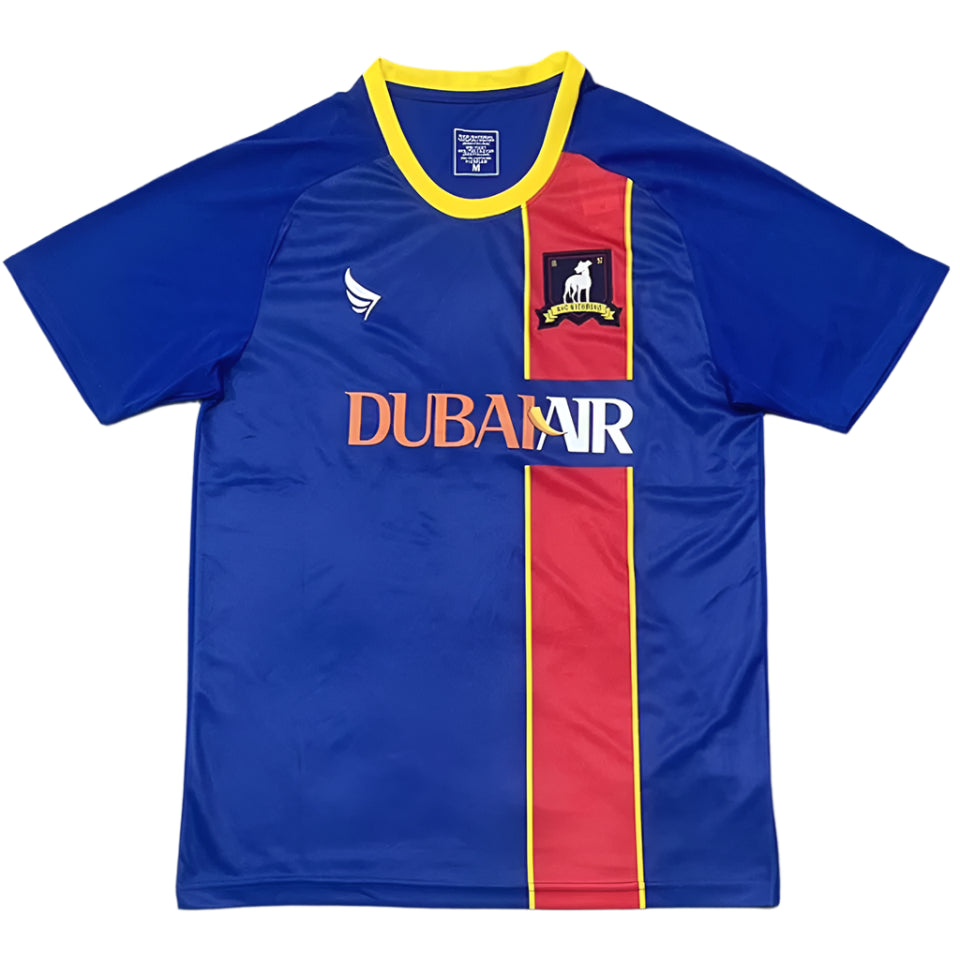 b9d87cf12ca91ff1 Blue soccer jersey with a red vertical stripe bordered in yellow, yellow-trim collar, crest on the chest, and the 'DUBAI VR' sponsor text across the front.