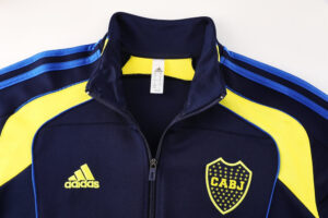 b9efe665 | UAE SPORT STORE Navy Adidas tracksuit jacket with yellow panels and a CABJ crest on the chest, zipper front, blue stripes along shoulders.