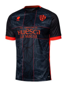 Dark blue Huesca football jersey with red trim, sponsor 'huesca la magia' and club crest.