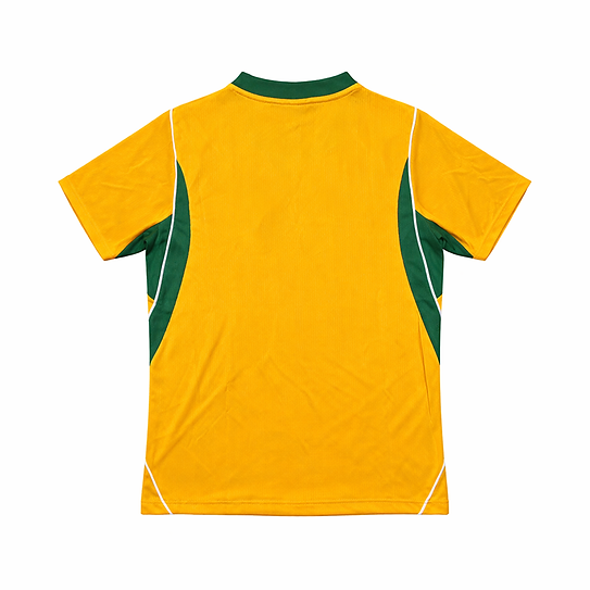 Back view of a bright yellow sports jersey with green side panels and white piping along the seams.