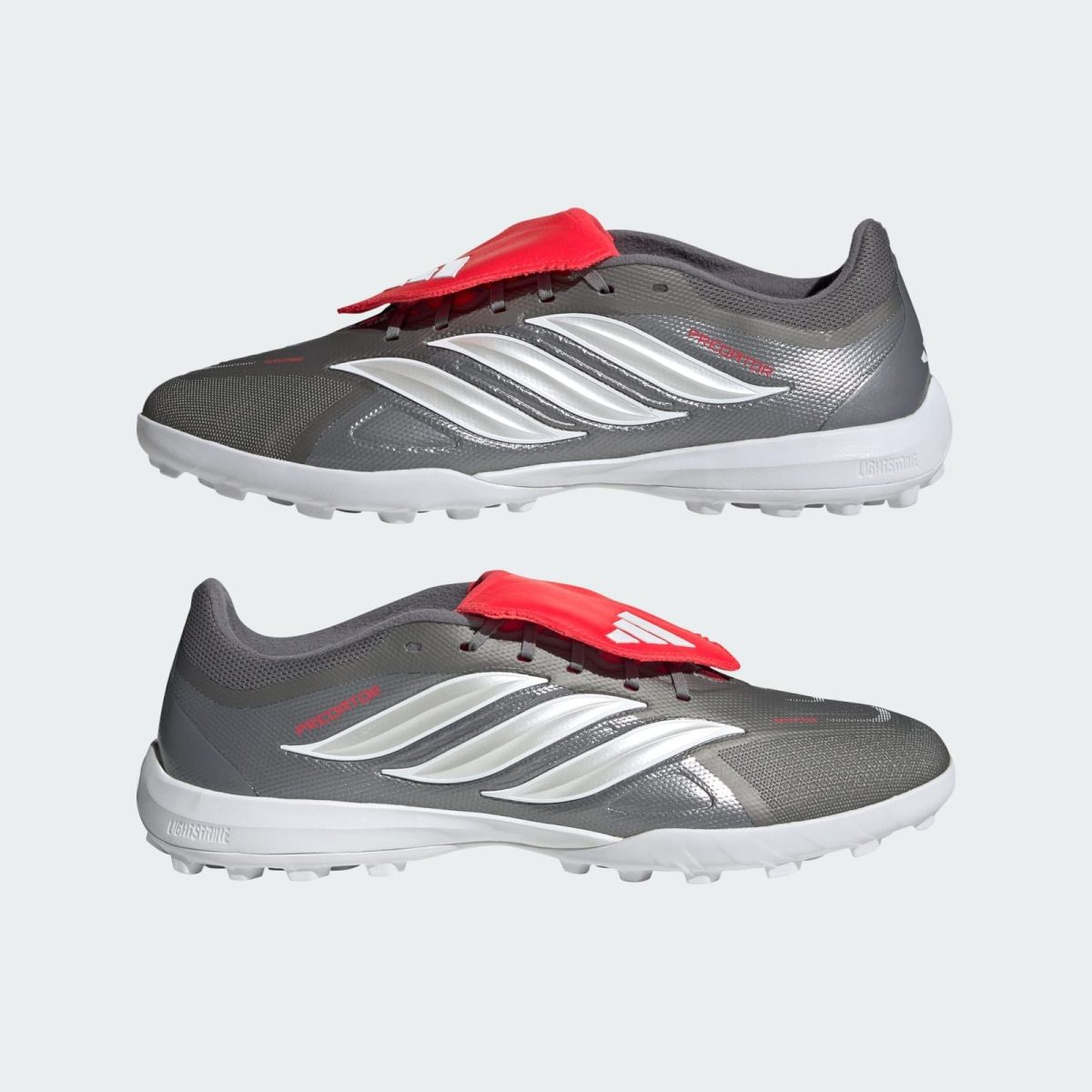 Grey running shoe with white sole, metallic silver side stripes, and a red tongue tag