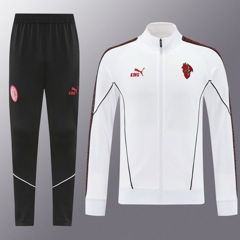 ba92bab2-74b6-47b3-be5a-5c1c5565ea70 White zip-up track jacket with red crest logo and black piping, paired with black jogger pants with a red emblem on the thigh.