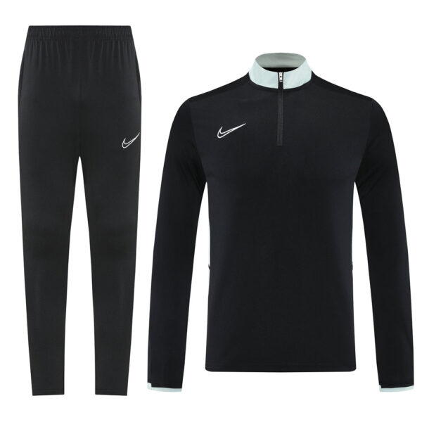 Black Nike tracksuit: long-sleeve pullover with light blue collar trim and half-zip, matching black jogger pants with a white swoosh.
