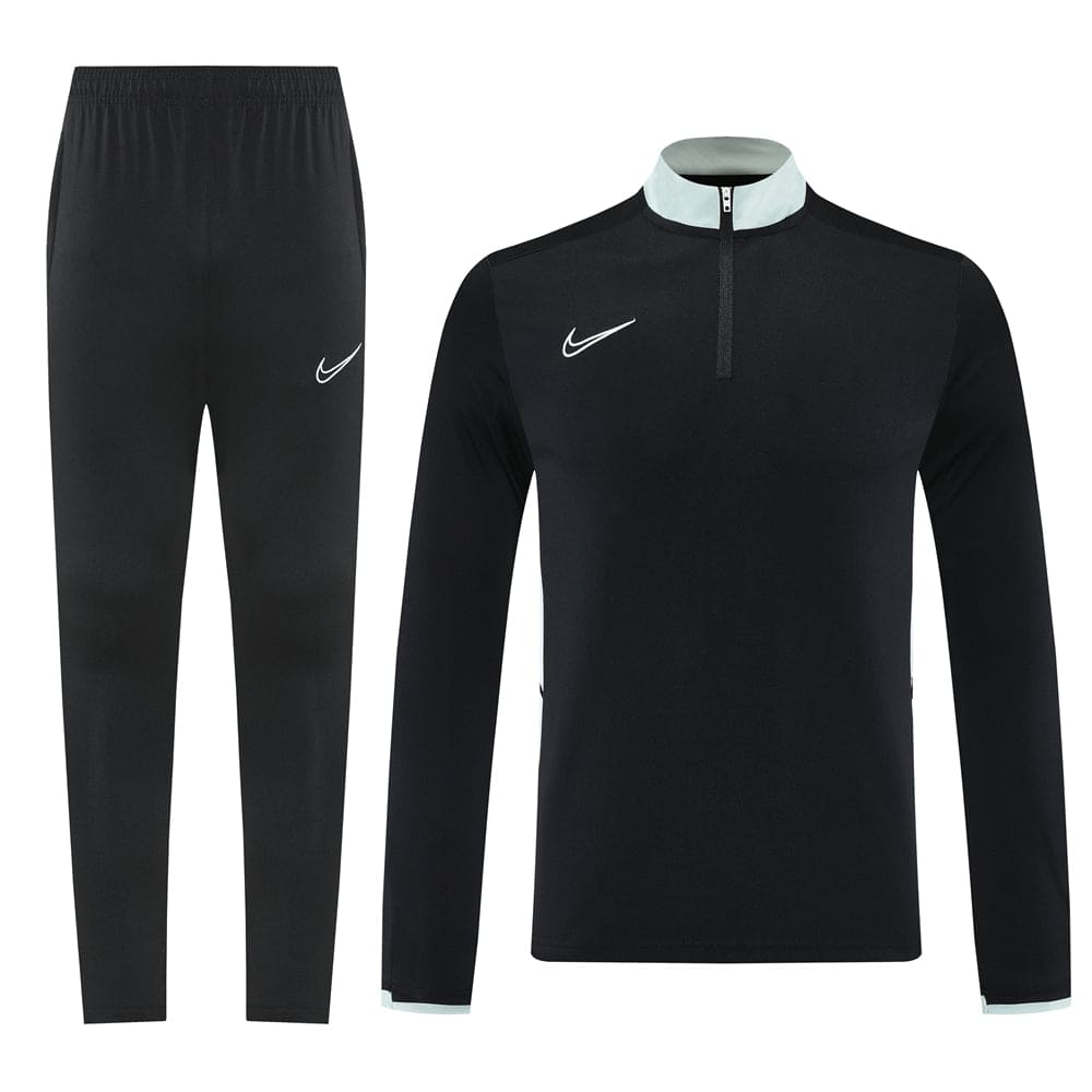 bac4b42e | UAE SPORT STORE Black Nike tracksuit: long-sleeve pullover with light blue collar trim and half-zip, matching black jogger pants with a white swoosh.