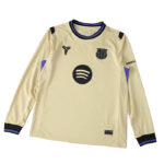 Beige football jersey with blue-purple trim featuring a Spotify logo circle and wavy lines on the chest, Barca crest on the left, and small logos on the chest and cuffs.