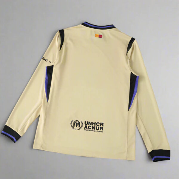 Beige athletic jersey with blue/black trim, back features UNHCR ACNUR logo and The UN Refugee Agency text.