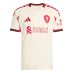 Cream-colored Liverpool FC football jersey with red crest, sponsor logo 'Standard Chartered', and red accents along shoulders and sleeves