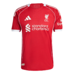 Red Liverpool FC home jersey with white piping, crest, Adidas logo, and Standard Chartered sponsor on the chest.